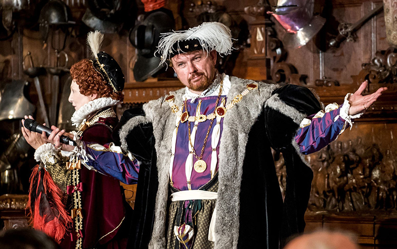 King Henry VIII standing at a banquet
